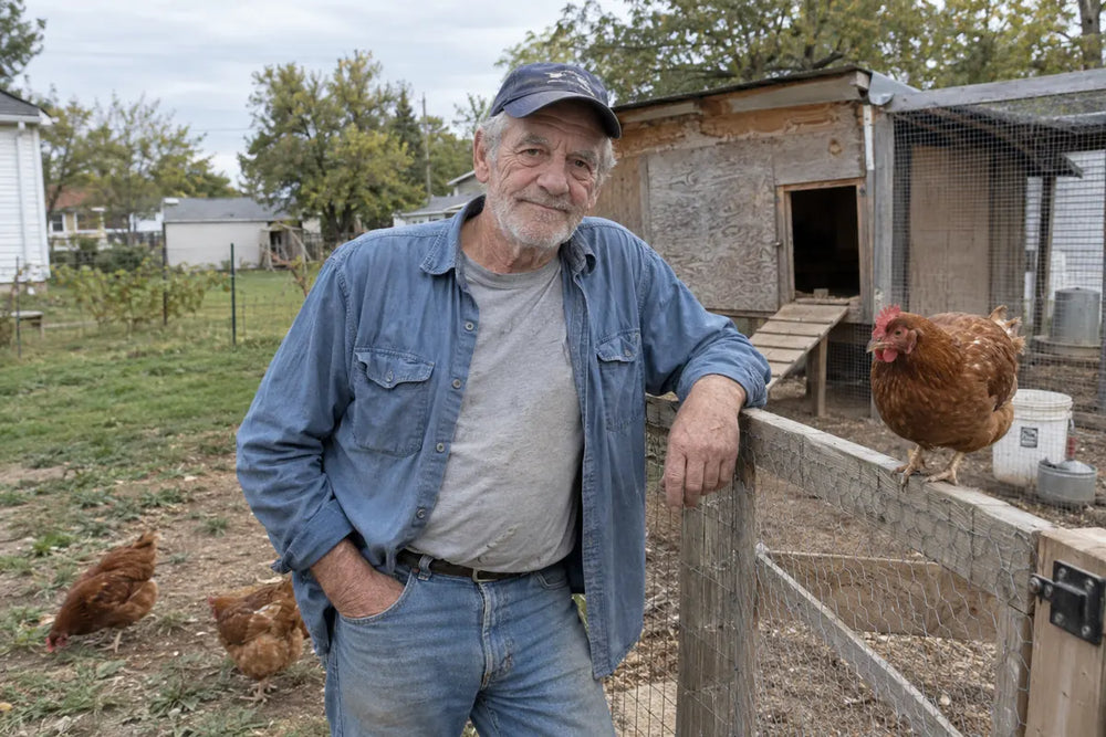 AI-generated portrayal of Walter in everyday work clothes beside a hen at his backyard coop.